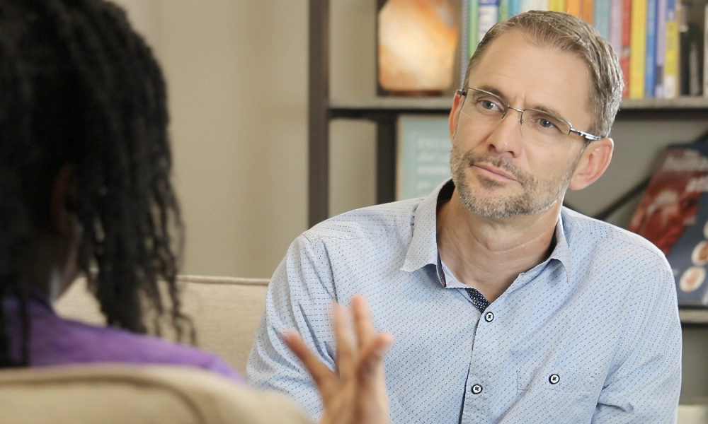 Daman Reynolds talking with a patient