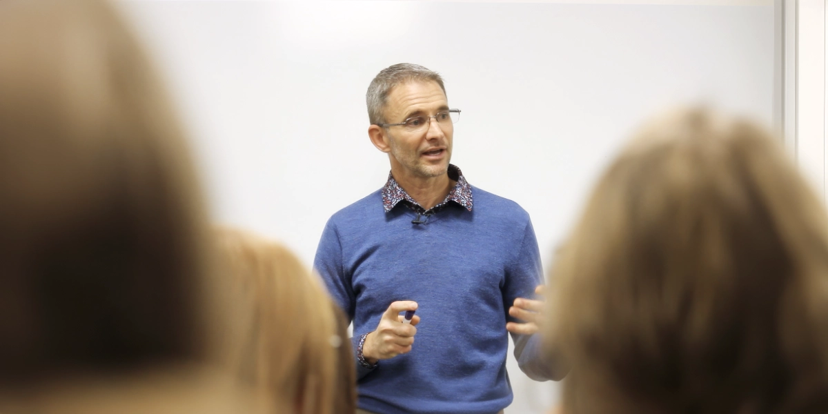 Daman Reynolds seated during a conversation