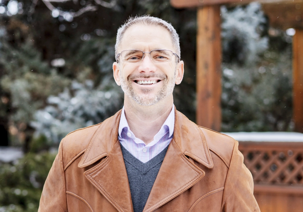 Daman standing outside, smiling at the camera